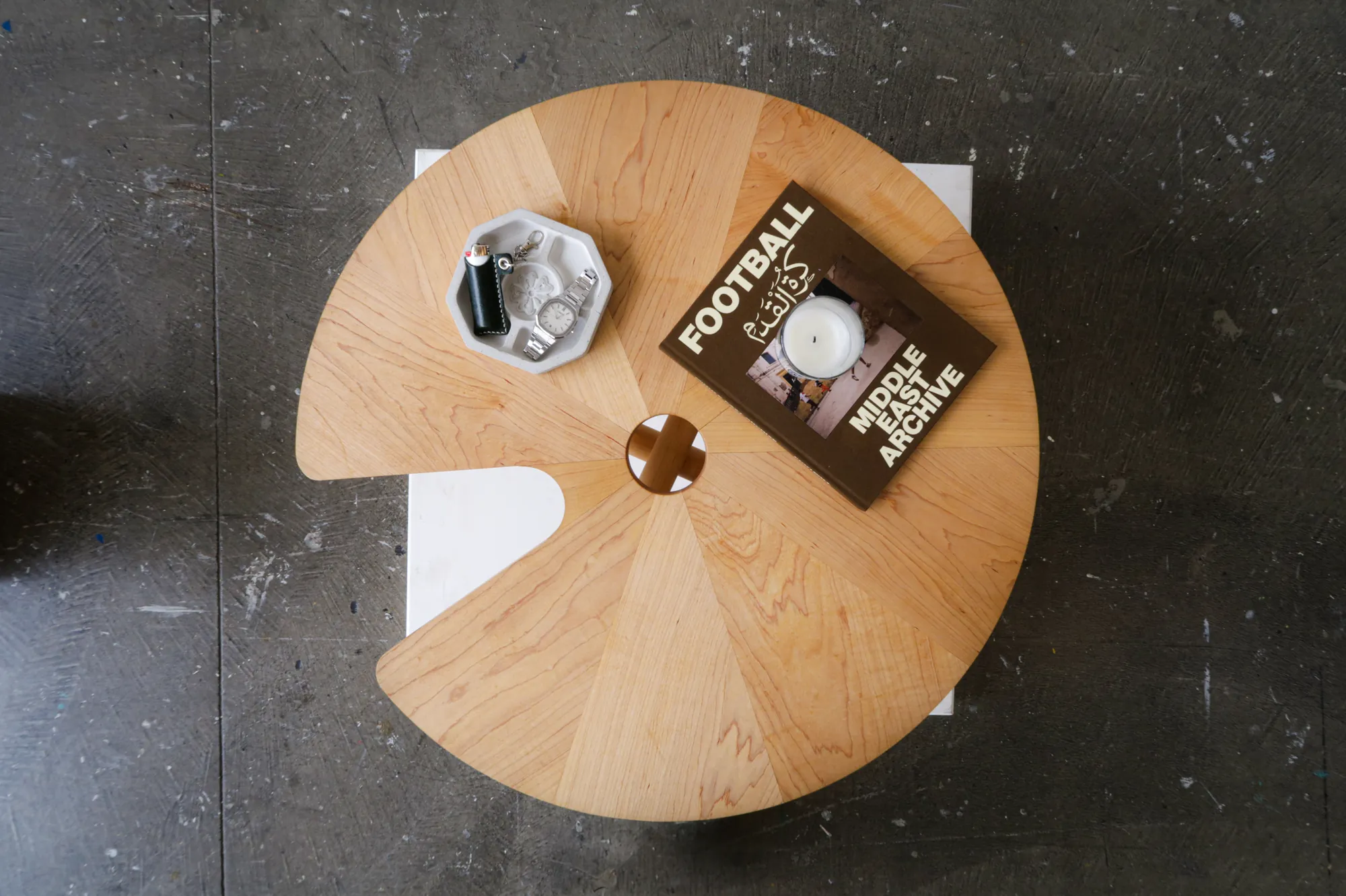 The Lily Pad coffee table from above, with a book and a candle on it