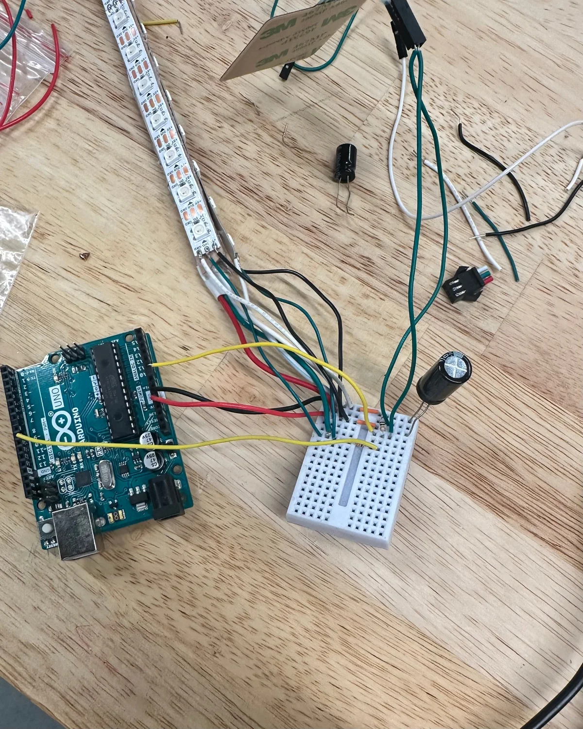An LED strip wired to an Arduino on a breadboard