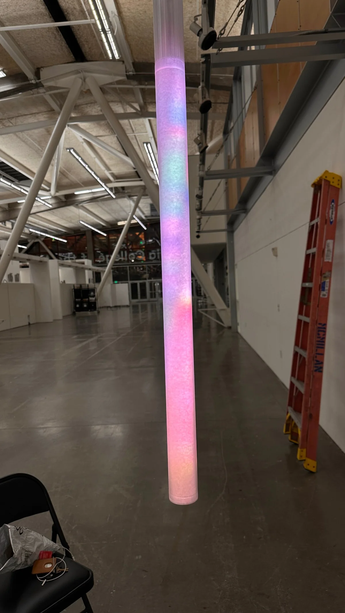 The first finished tube lit up in the empty exhibition hall